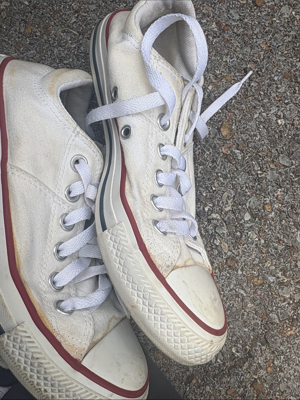 Classic white canvas sneakers with red stripe